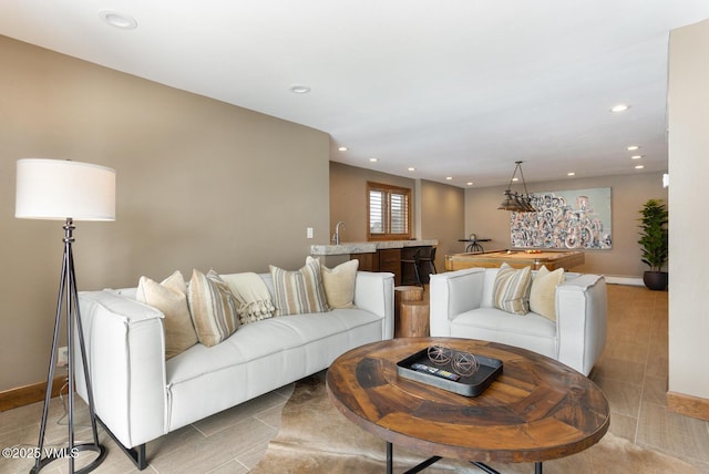 living room featuring recessed lighting and baseboards