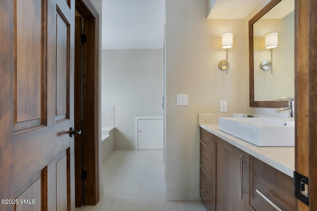 full bath with tile patterned floors, a bath, and vanity