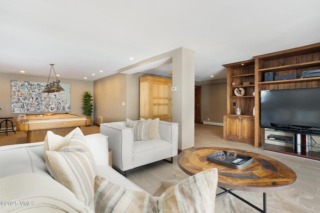 living area featuring a baseboard radiator and recessed lighting