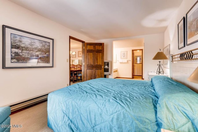 bedroom with carpet floors and a baseboard radiator