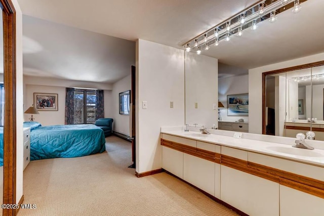 bathroom featuring double vanity, track lighting, a sink, and connected bathroom