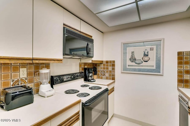 kitchen with black microwave, decorative backsplash, electric stove, light countertops, and white cabinetry