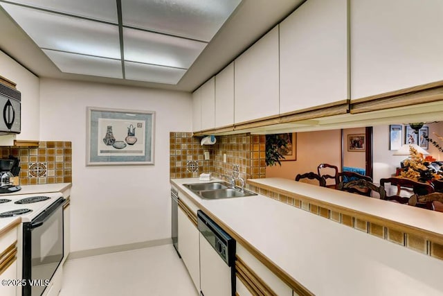 kitchen with range with electric cooktop, white dishwasher, a sink, and white cabinetry