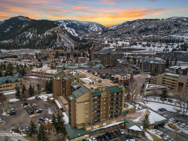 snowy aerial view featuring a mountain view