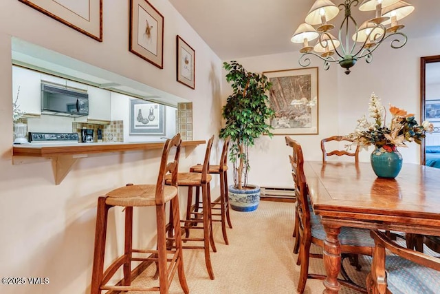 dining area featuring a baseboard radiator and a chandelier