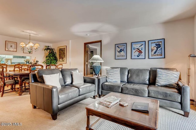 living room featuring light carpet and a notable chandelier