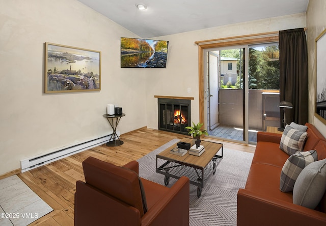 1050 W Beaver Creek Blvd Unit E-201, Avon, CO 81620 - living area featuring a baseboard heating unit, lofted ceiling, a lit fireplace, and wood finished floors