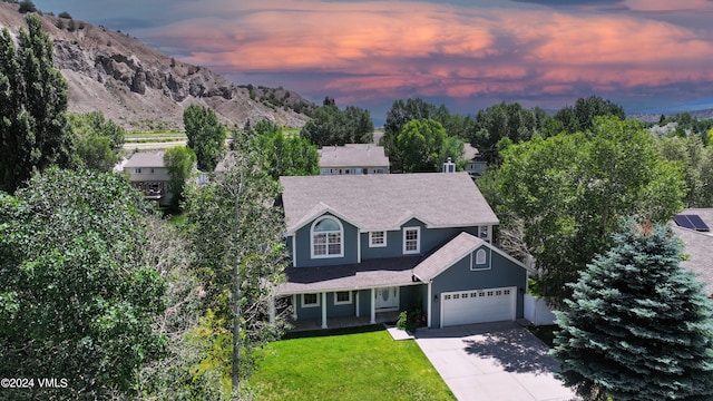 view of front of house featuring a mountain view and a lawn