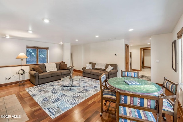 living area featuring recessed lighting, light wood-style flooring, and baseboards