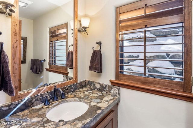 bathroom featuring vanity and visible vents