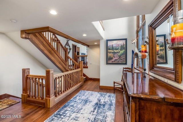 hallway featuring stairway, recessed lighting, baseboards, and wood finished floors