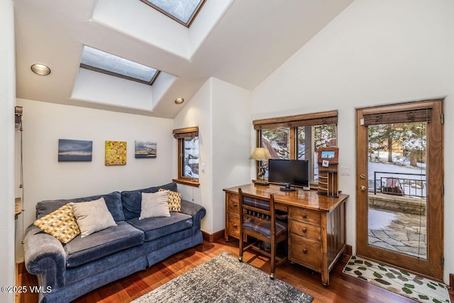 office area featuring vaulted ceiling with skylight, recessed lighting, wood finished floors, and baseboards