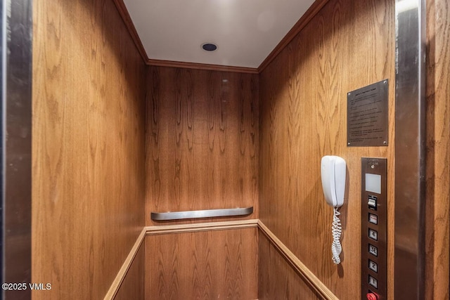 room details featuring elevator and ornamental molding