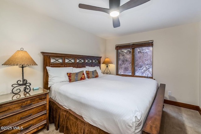 carpeted bedroom with ceiling fan and baseboards