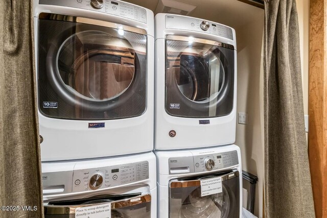 laundry room featuring laundry area and stacked washing maching and dryer