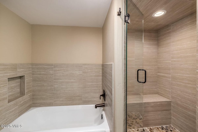 full bath with a bath, recessed lighting, and a stall shower