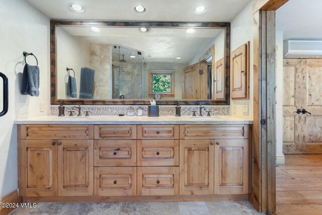 bathroom featuring hardwood / wood-style floors, vanity, a wall mounted AC, and an enclosed shower