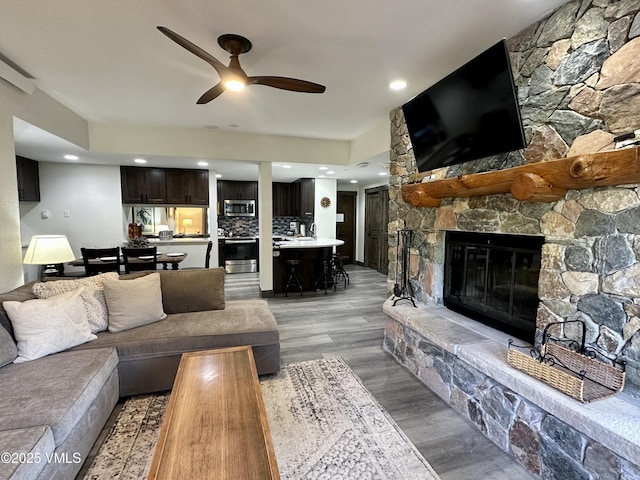 120 Offerson Rd Unit A160, Beaver Creek, CO 81620 - living area with a ceiling fan, light wood finished floors, a stone fireplace, and recessed lighting