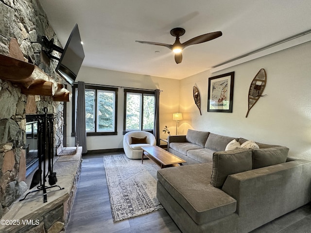 120 Offerson Rd Unit A160, Beaver Creek, CO 81620 - living area featuring a stone fireplace, a ceiling fan, and wood finished floors