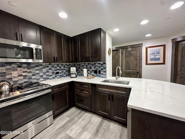 120 Offerson Rd Unit A160, Beaver Creek, CO 81620 - kitchen featuring stainless steel appliances, a sink, light wood-style flooring, backsplash, and recessed lighting