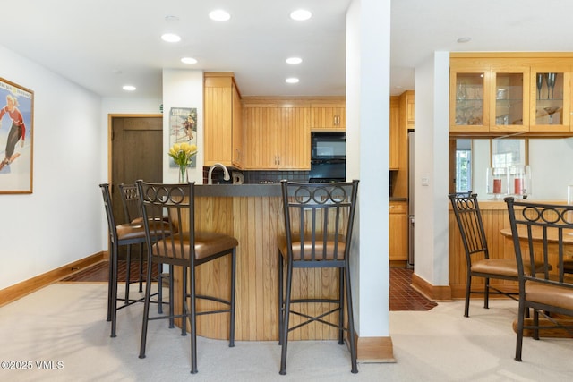 120 Offerson Rd Unit 2320, Beaver Creek, CO 81620 - kitchen featuring black microwave, light colored carpet, a kitchen bar, recessed lighting, and backsplash