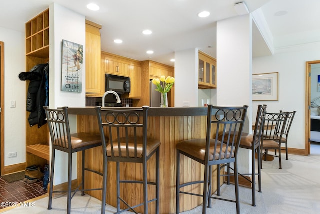 120 Offerson Rd Unit 2320, Beaver Creek, CO 81620 - kitchen with black microwave, freestanding refrigerator, a peninsula, recessed lighting, and dark countertops