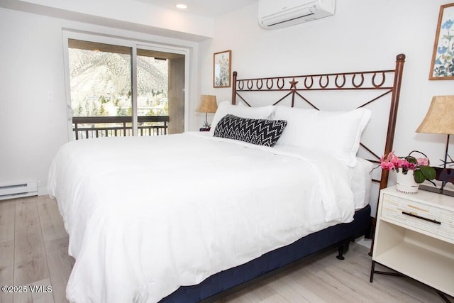 bedroom with access to exterior, a baseboard radiator, recessed lighting, an AC wall unit, and wood finished floors