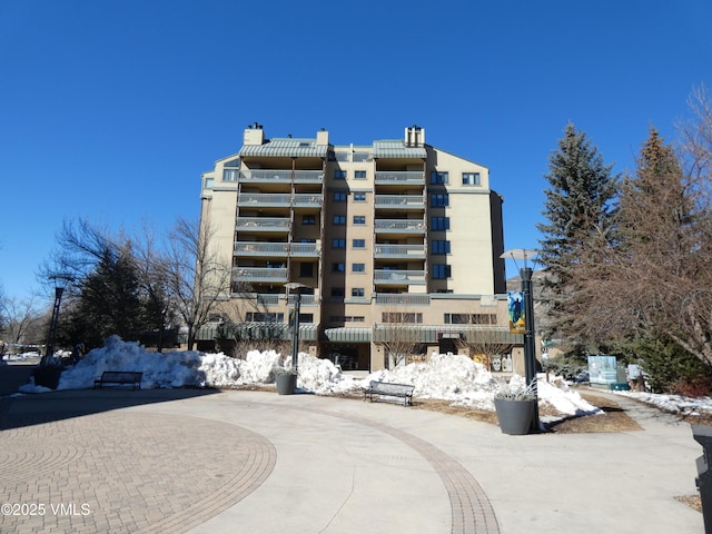 view of building exterior featuring curved driveway