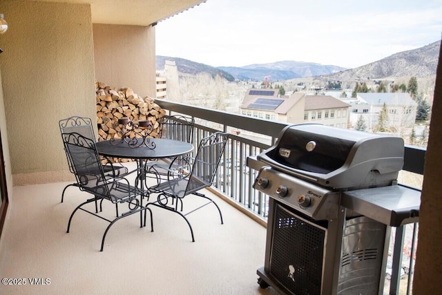 balcony featuring a mountain view and grilling area