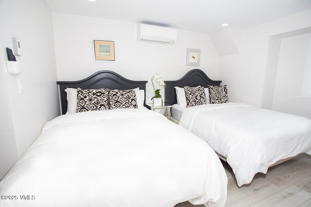 bedroom with recessed lighting, a wall mounted air conditioner, and wood finished floors