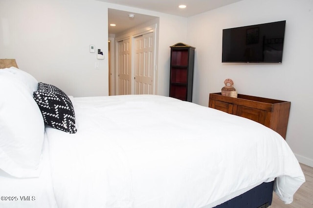 bedroom featuring light wood-style flooring and recessed lighting