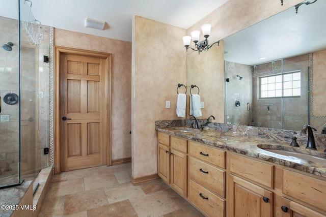 2 Anvil Cir, Edwards, CO 81632 - full bath featuring double vanity, a shower stall, stone finish floors, and a chandelier