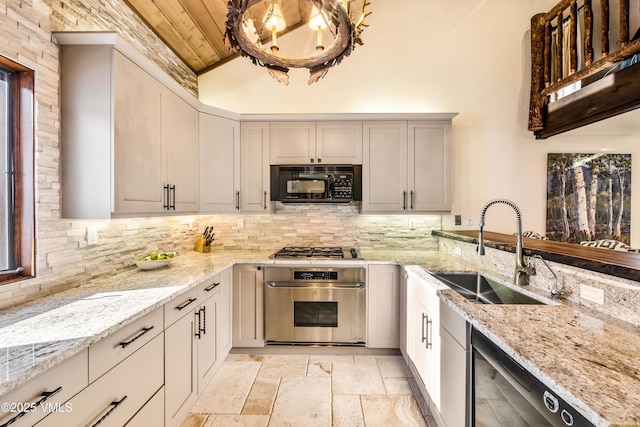 kitchen with sink, wooden ceiling, stainless steel appliances, light stone countertops, and backsplash