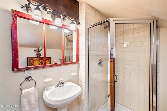 bathroom featuring walk in shower and sink