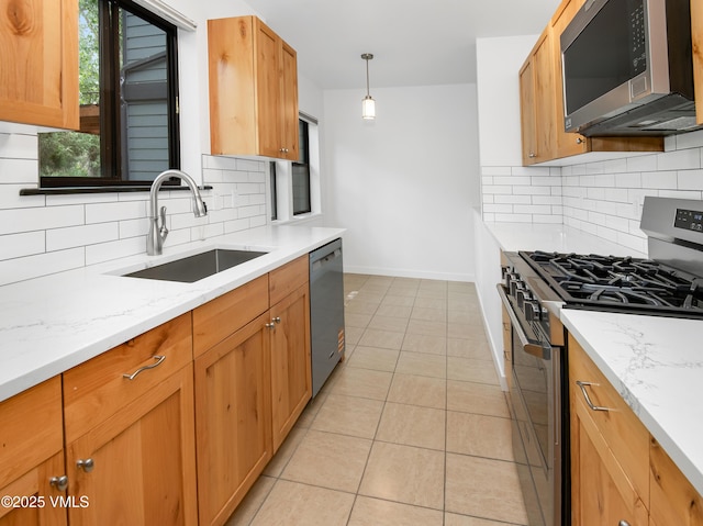 2403 Draw Spur Unit 2, Avon, CO 81620 - kitchen with appliances with stainless steel finishes, decorative backsplash, light tile patterned flooring, and light stone countertops