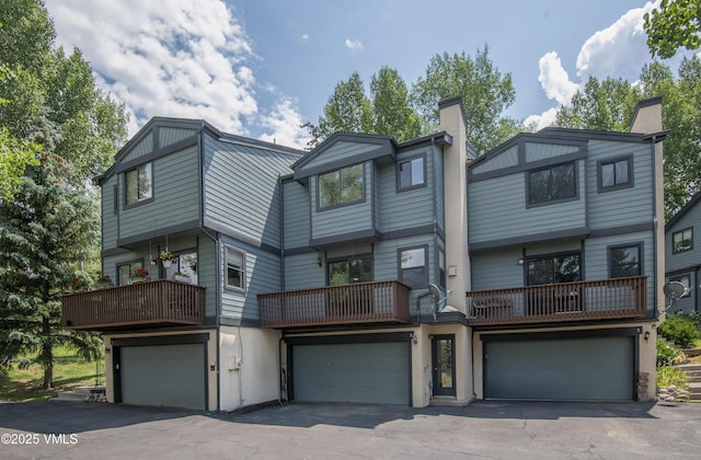 2403 Draw Spur Unit 2, Avon, CO 81620 - back of property with a chimney, a garage, a balcony, and driveway