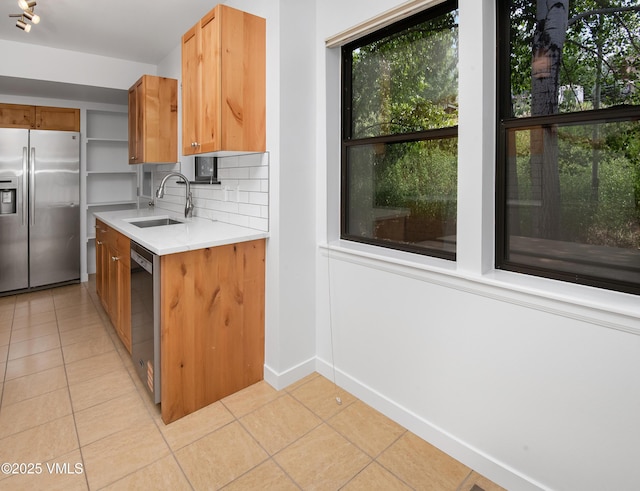 2403 Draw Spur Unit 2, Avon, CO 81620 - kitchen featuring stainless steel appliances, light tile patterned flooring, healthy amount of natural light, and light countertops