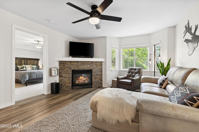 601 Crazy Horse Cir Unit 601, Edwards, CO 81632 - living area featuring a ceiling fan, wood finished floors, and a fireplace