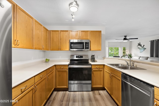 601 Crazy Horse Cir Unit 601, Edwards, CO 81632 - kitchen with stainless steel appliances, light wood finished floors, ceiling fan, and light countertops