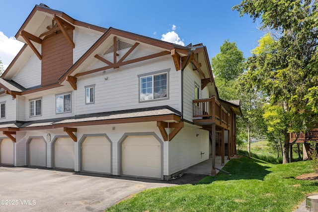 601 Crazy Horse Cir Unit 601, Edwards, CO 81632 - view of side of property featuring a yard, an attached garage, driveway, a deck, and stairway