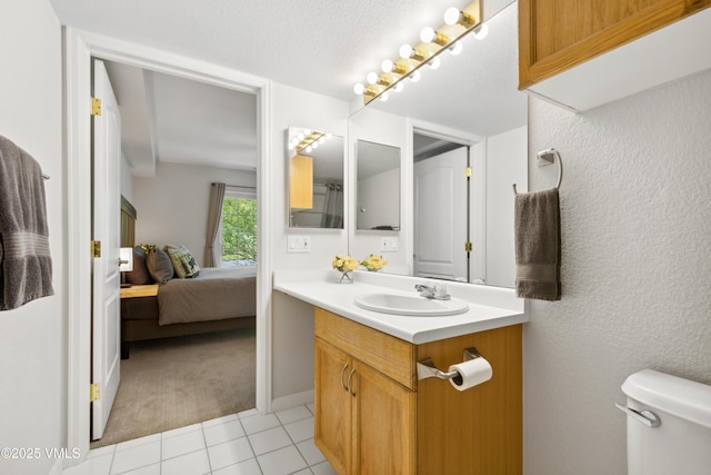 601 Crazy Horse Cir Unit 601, Edwards, CO 81632 - bathroom featuring vanity, tile patterned flooring, ensuite bathroom, a textured wall, and a textured ceiling