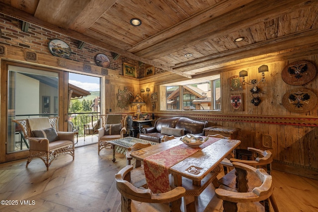 225 Wall St Unit 301, Vail, CO 81657 - dining area featuring a wood ceiling with exposed beams, wooden walls, and hardwood / wood-style floors