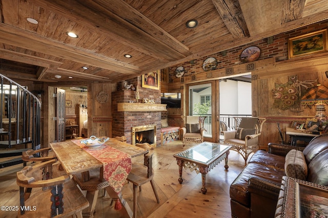225 Wall St Unit 301, Vail, CO 81657 - living area with a fireplace, wood walls, hardwood / wood-style flooring, a wood ceiling with exposed beams, and recessed lighting
