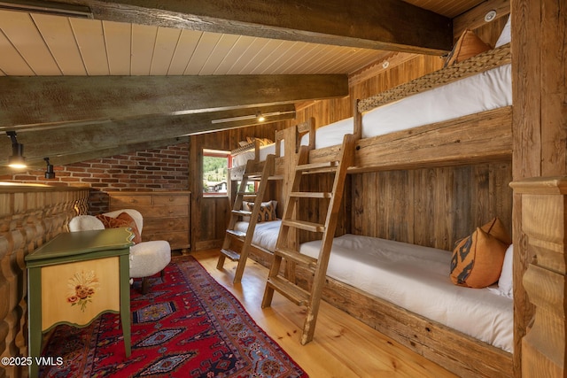225 Wall St Unit 301, Vail, CO 81657 - bedroom featuring wooden walls, wood finished floors, wooden ceiling, and brick wall
