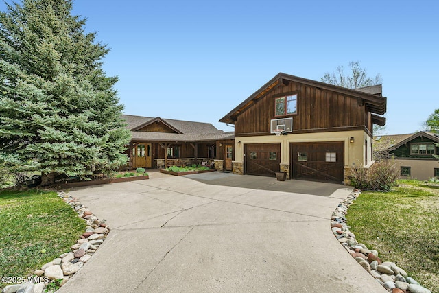 51 Silver Spur, Eagle, CO 81631 - view of front of home featuring stone siding, concrete driveway, and a front lawn