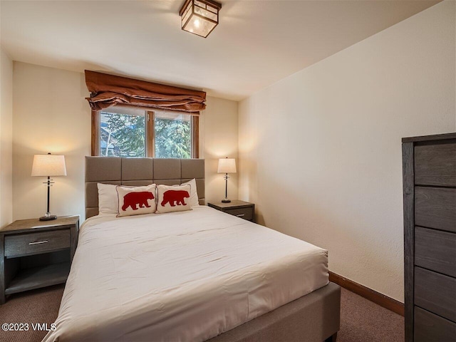 carpeted bedroom featuring baseboards