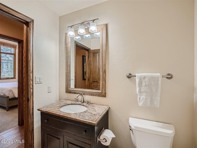 bathroom featuring toilet and vanity