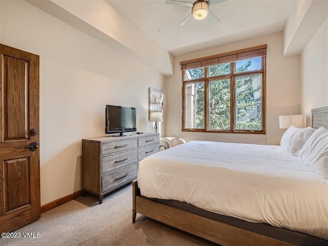 bedroom featuring light carpet, ceiling fan, and baseboards