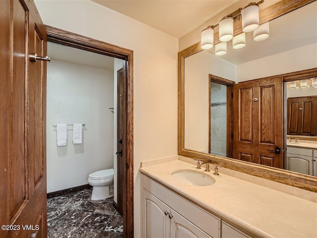 bathroom with baseboards, toilet, and vanity