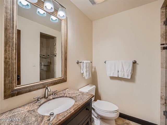 bathroom with vanity, toilet, and a shower stall